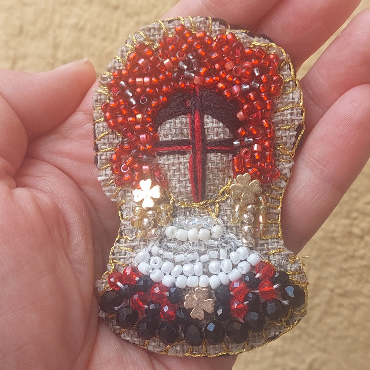 Handmade Ukrainian Motanka doll brooch with red black white beads and gold embroidery