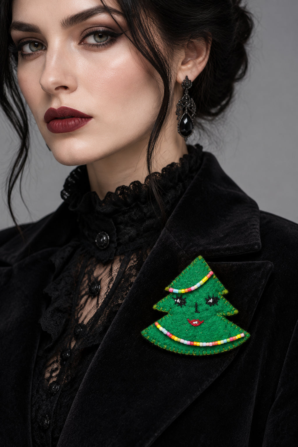 Handmade felt Christmas tree brooch worn as a festive holiday accessory