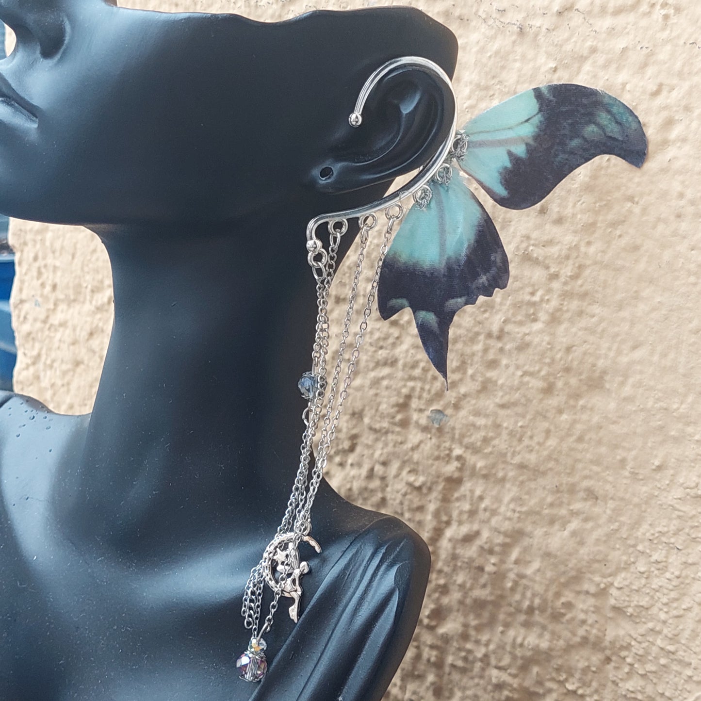 Handmade dark fantasy ear cuff with dangling chains - side angle view