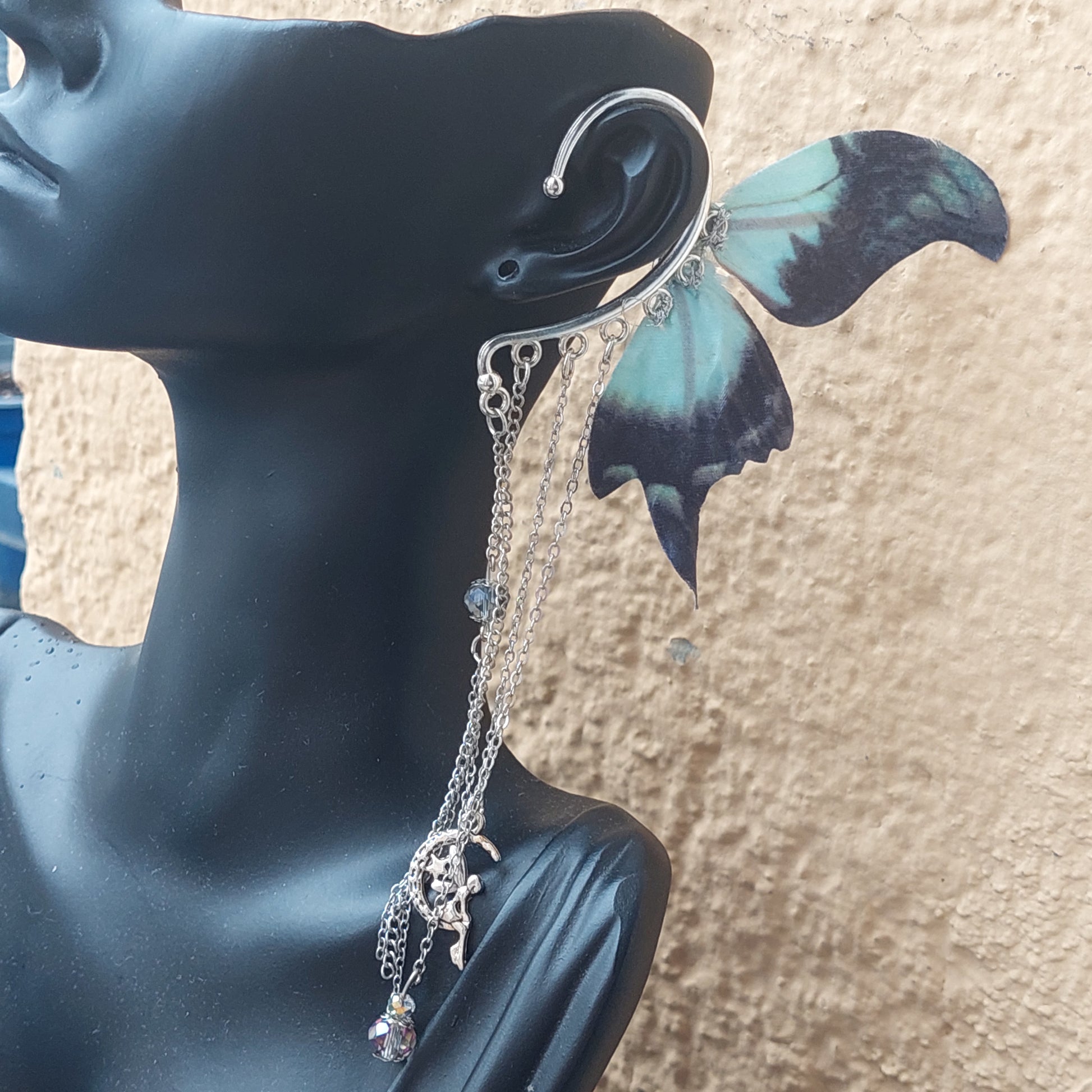 Handmade dark fantasy ear cuff with dangling chains - side angle view