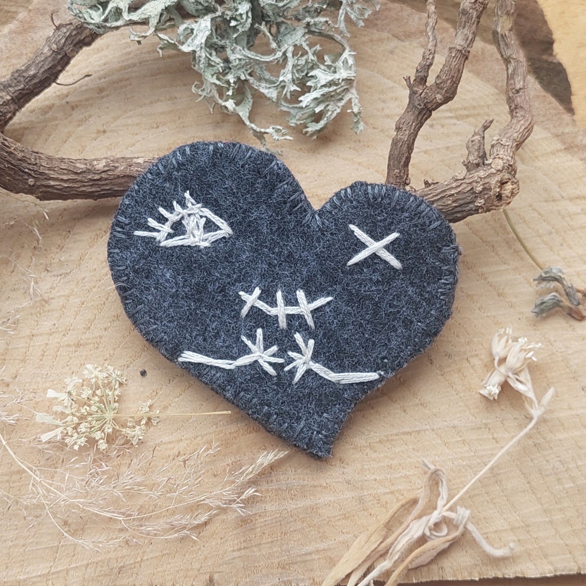 Hand-embroidered by hand and released in a strictly limited edition, the Stitched Heart Brooch is a quiet symbol of resilience — wounded, yet unbroken. Crafted from dark grey felt with contrasting hand stitching and finished with a vintage metal pin, each piece carries subtle variations that make it uniquely yours. A meaningful gothic talisman designed to accompany you every day.