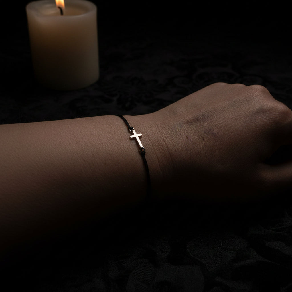 Black macrame cross bracelet worn on wrist – gothic spiritual jewelry handmade by Angelenade