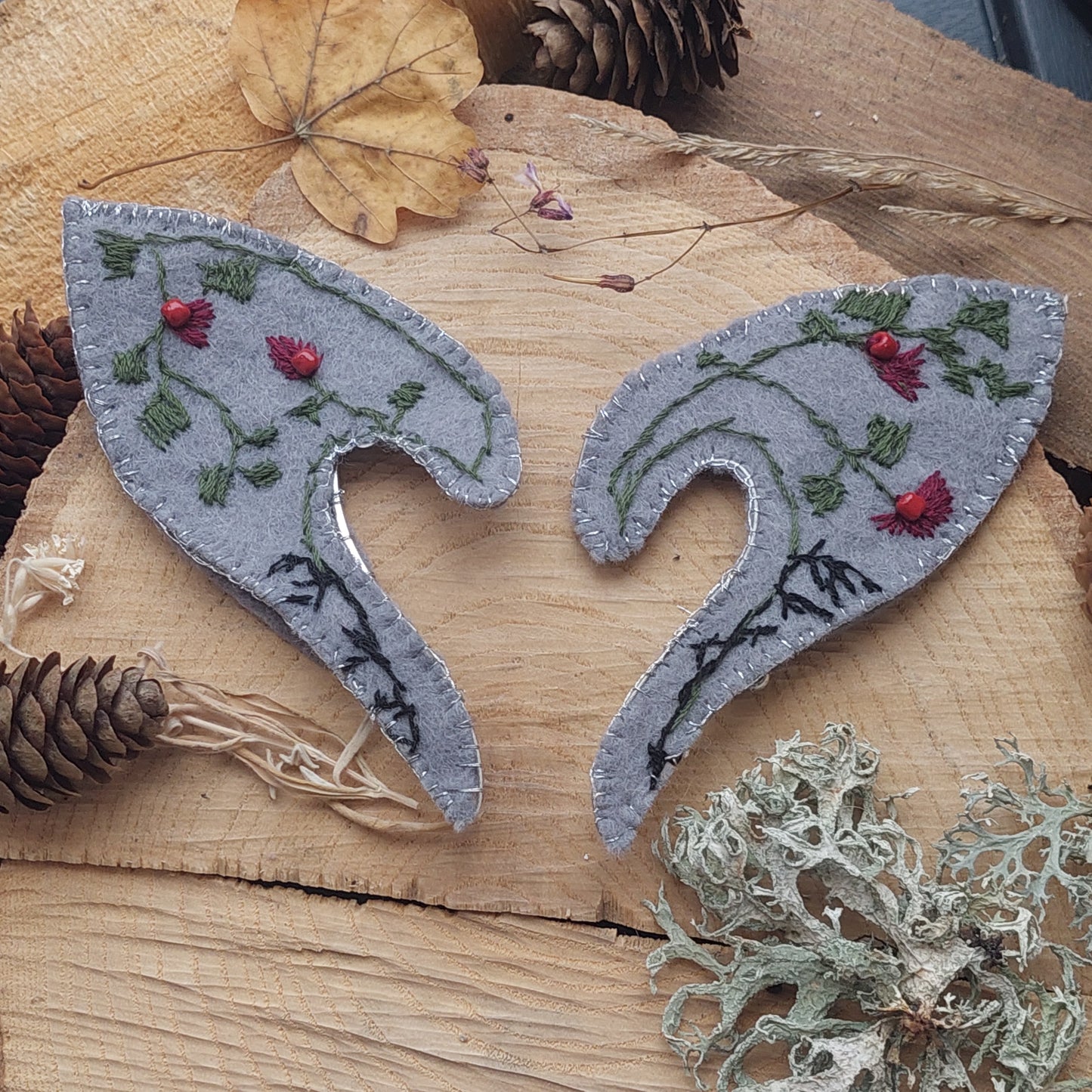 Hand-embroidered magical flower with silver threads and red coral beads.
Each detail is stitched by hand, making every pair truly one of a kind.