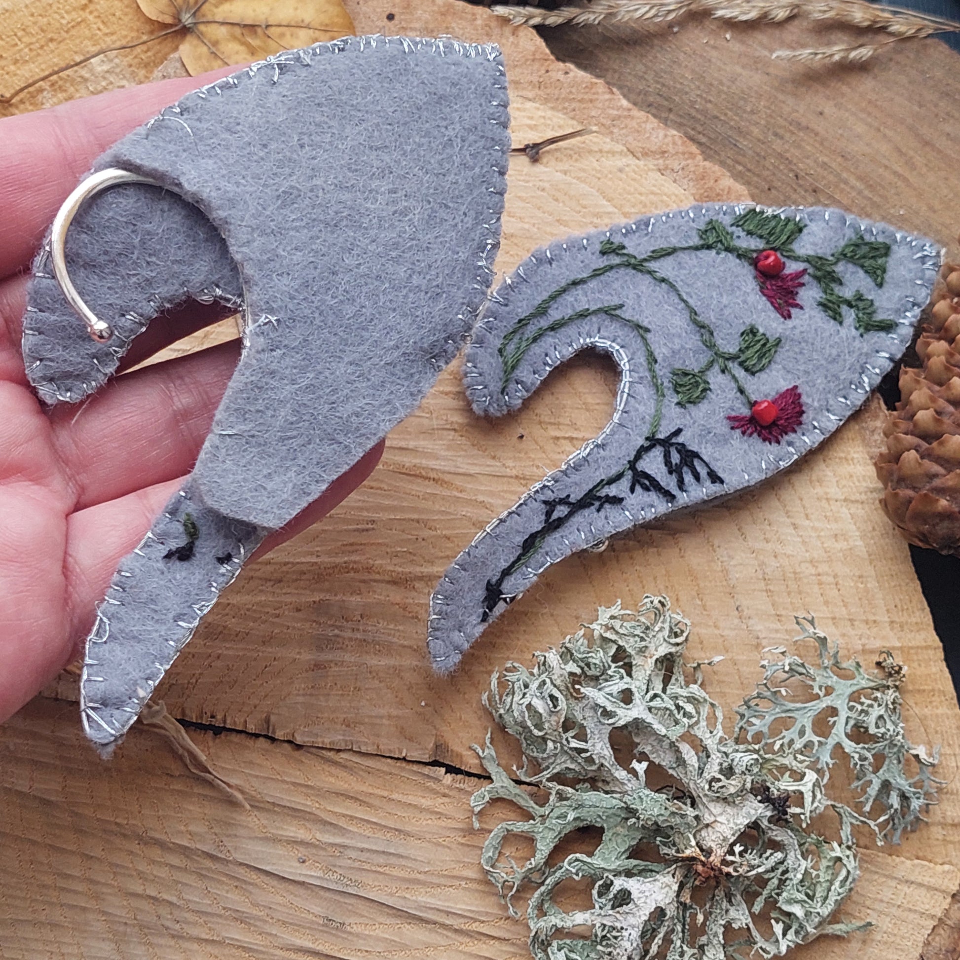 Made from felt, green and burgundy embroidery floss, silver threads, red coral beads, and metal hooks.
Carefully crafted in very small batches.