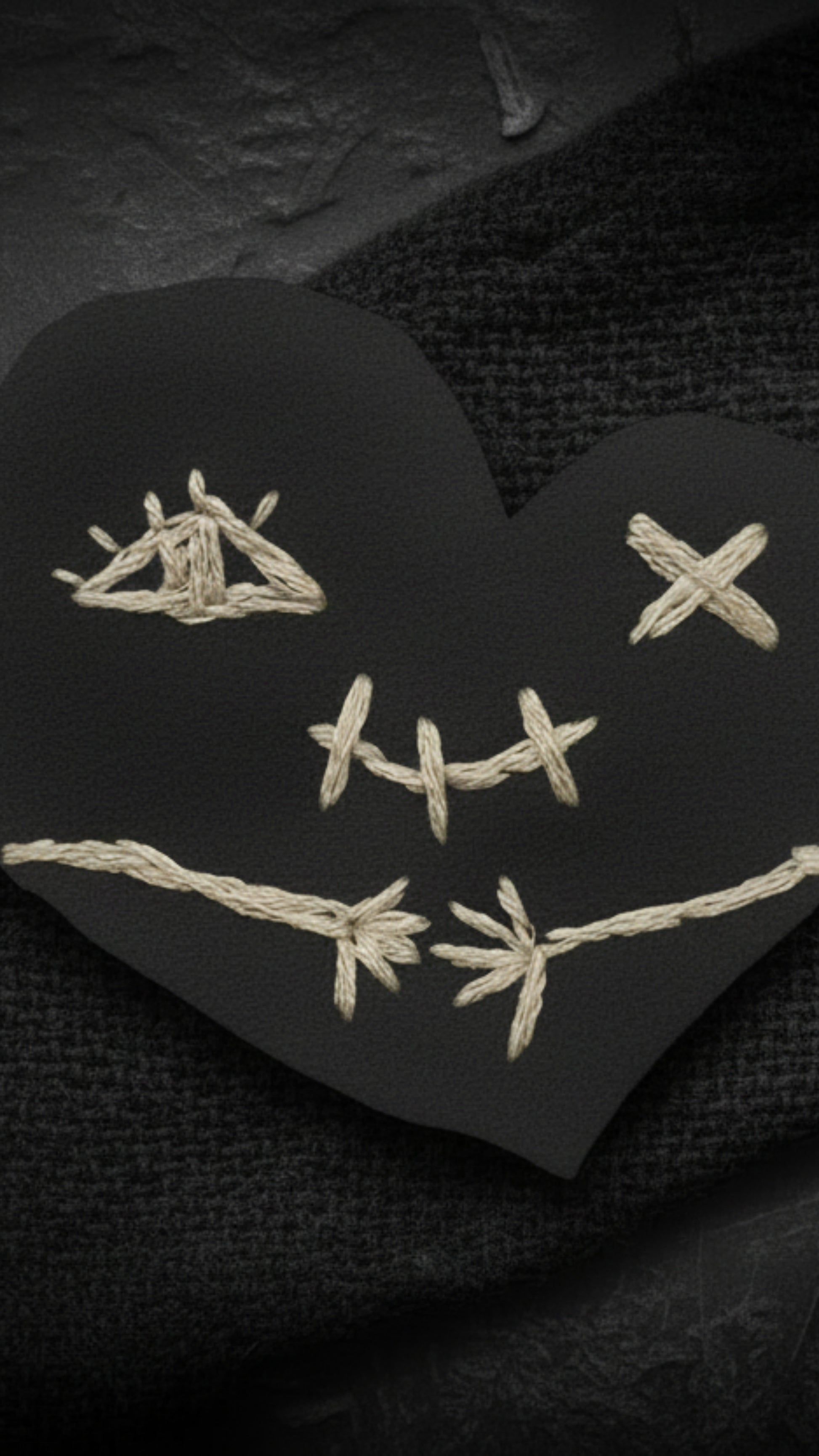 Dark gothic phone wallpapers featuring a stitched heart
