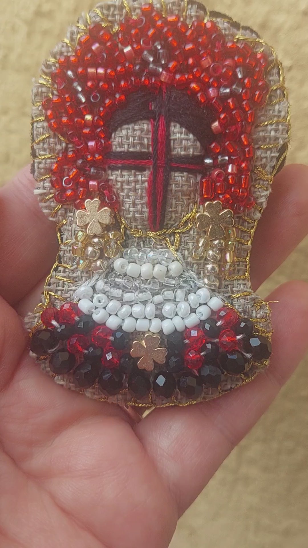 Back of handmade Ukrainian Motanka brooch showing textile base and pin closure